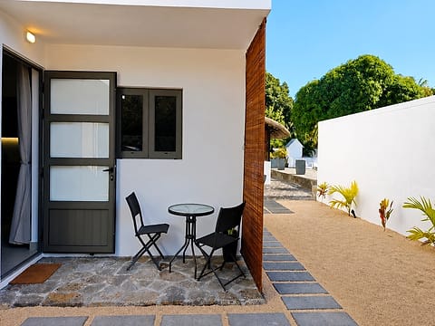 A private terrace with its small table, outside the door of one of the units